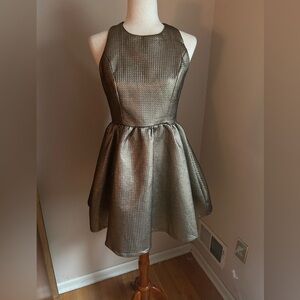 Ina fit and flare minidress. M. Metallic gold. Sleeveless w/fabulous back detail